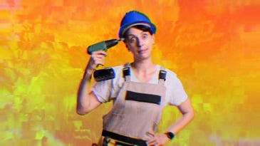 A woman holding a drill to her temple looking exasperated.