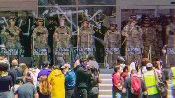 California National Guard standing in front of a group of protesters.